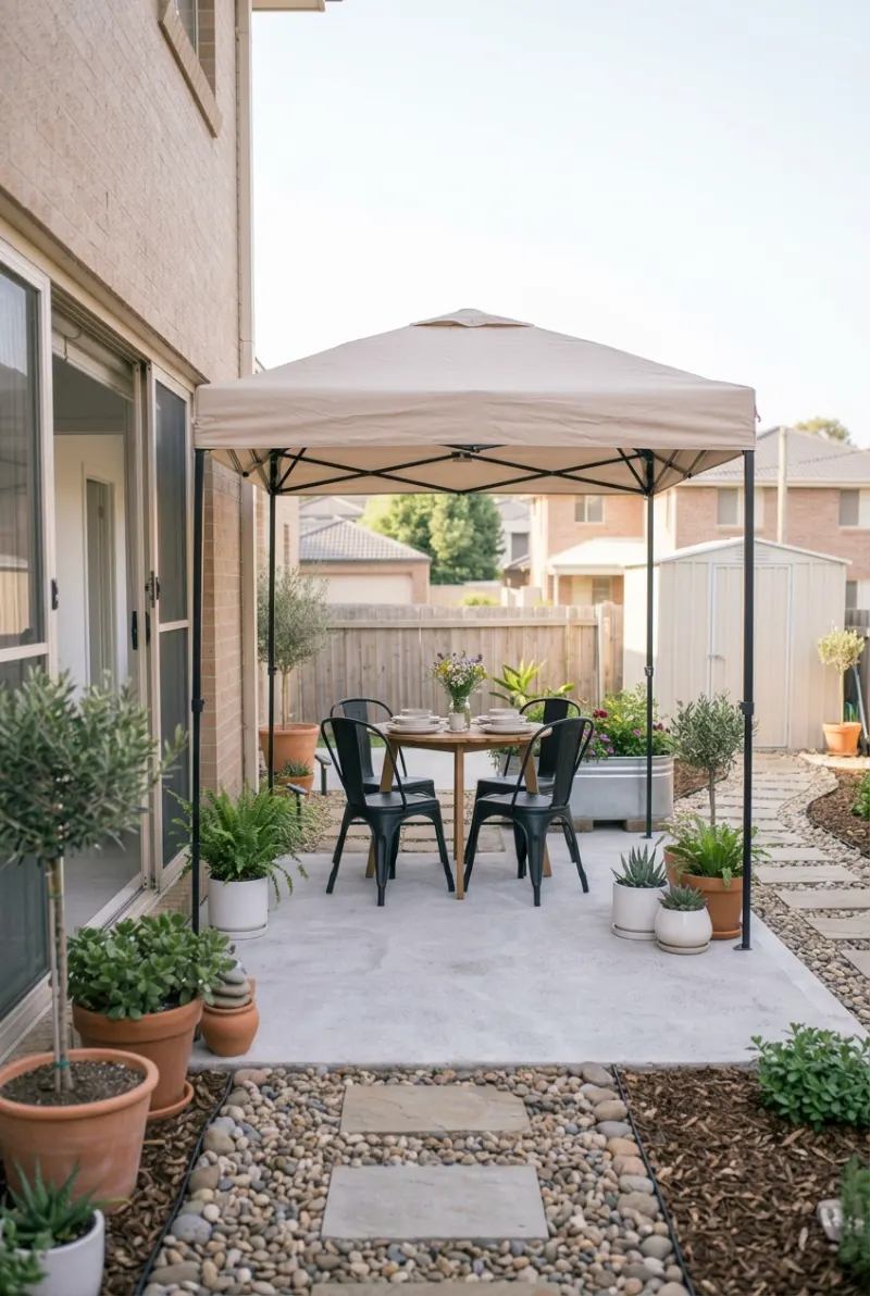 Portable beige canopy providing shade over a rental backyard dining area.
